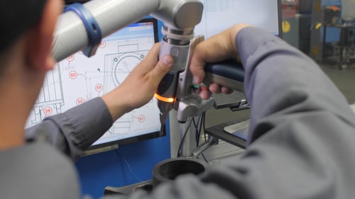 Eagle CNC employee using the Faro laser arm